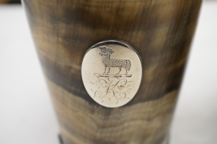 A pair of 19th century white metal mounted horn beakers, with oval appliqués engraved with a sheep and initial, makers mark only IP, one lacking base mount, height 12.5cm.